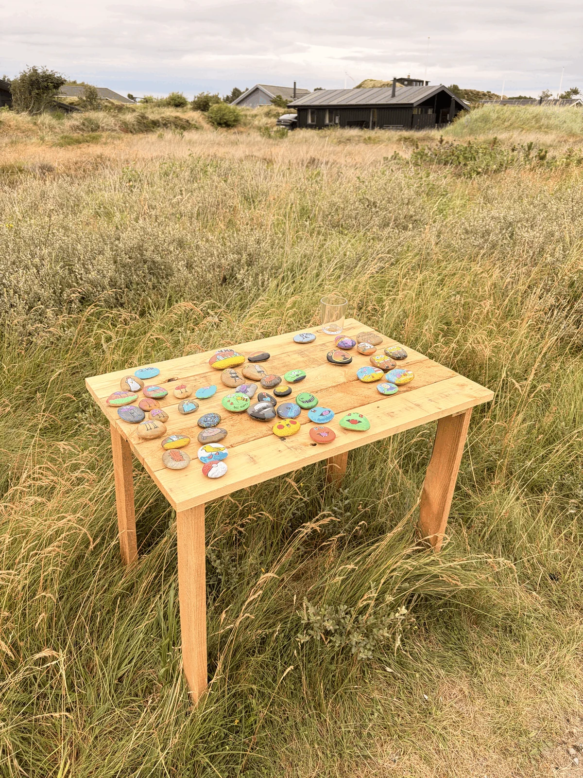A table of painted stones to be sold on a trust basis