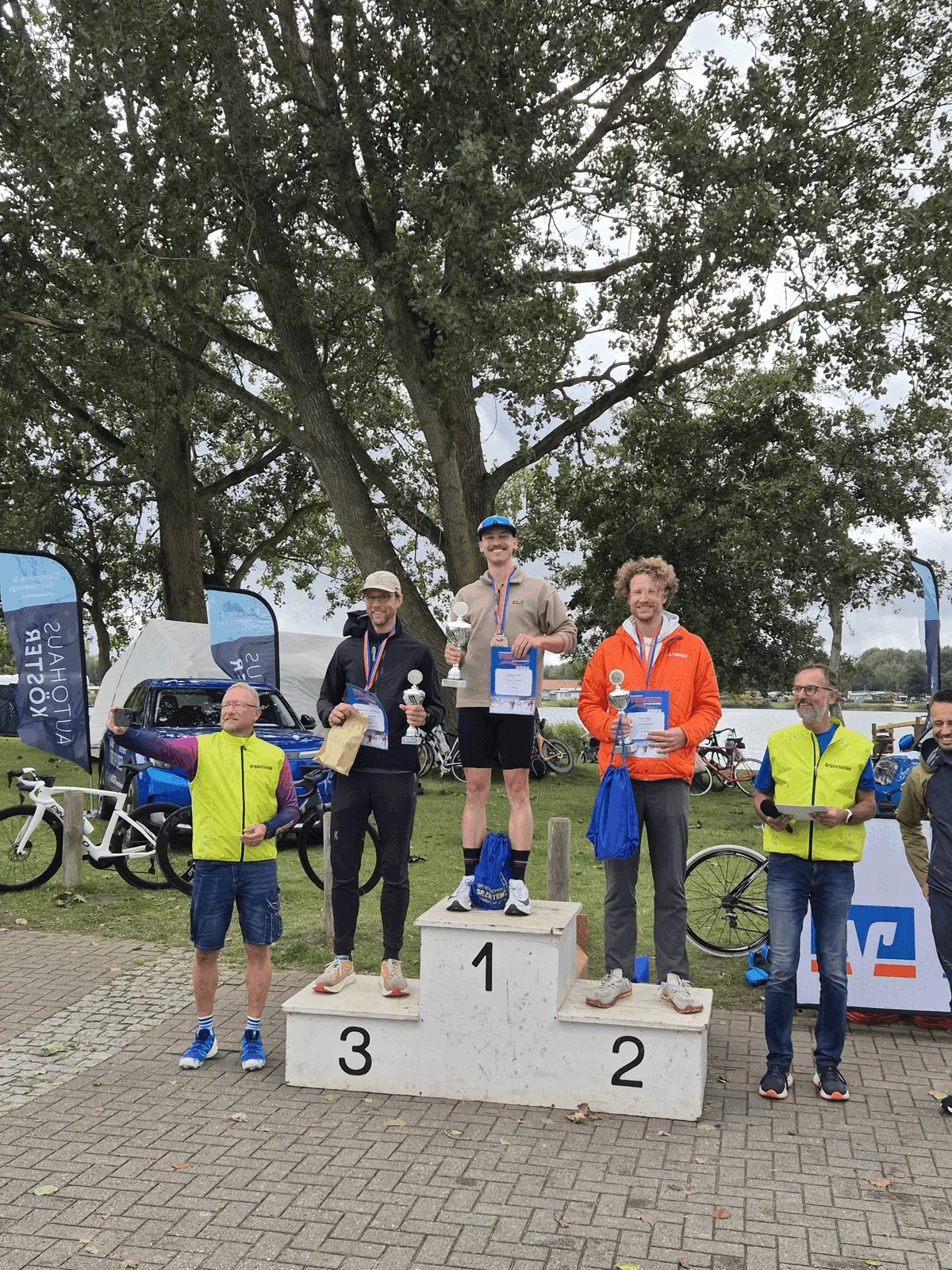 Me standing on the 2nd place step of the podium of a triathlon race.